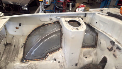 IMR bead-rolled front tubs welded into a Mazda RX3 engine bay either side of the strut tower