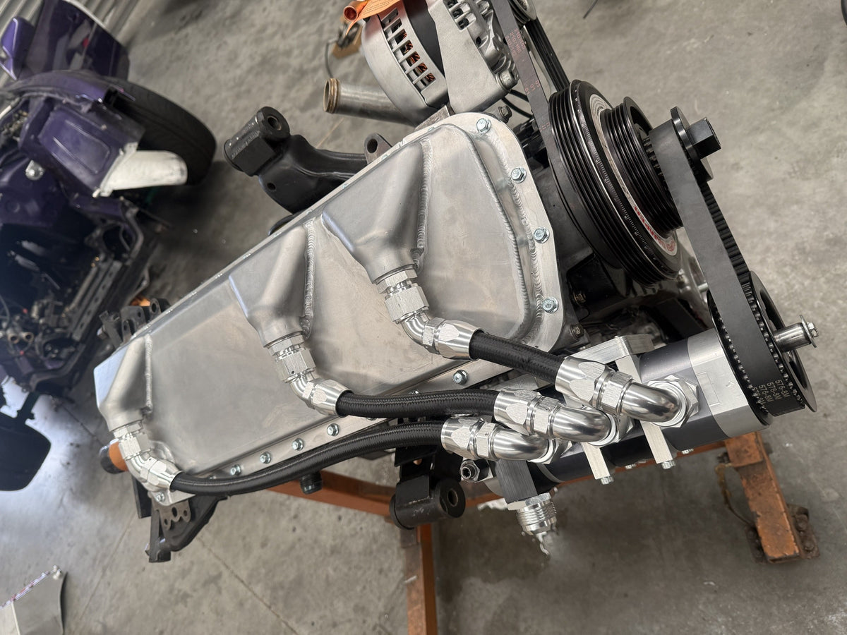 Fabricated alloy RB dry sump pan with three scavenge lines running to a 4-stage dry sump pump on the IMR pump mount